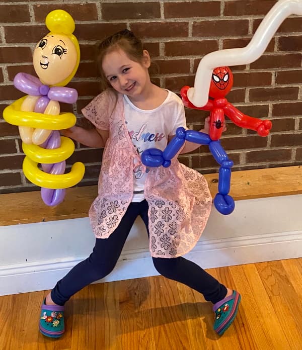 A balloon artist presenting a colorful creation