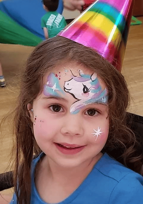 A colorful unicorn face-painting design