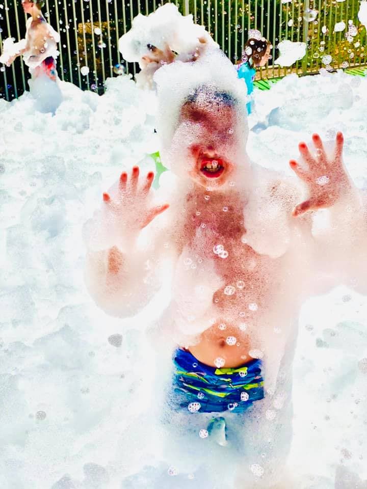 A child playing in a Party Troupe foam party